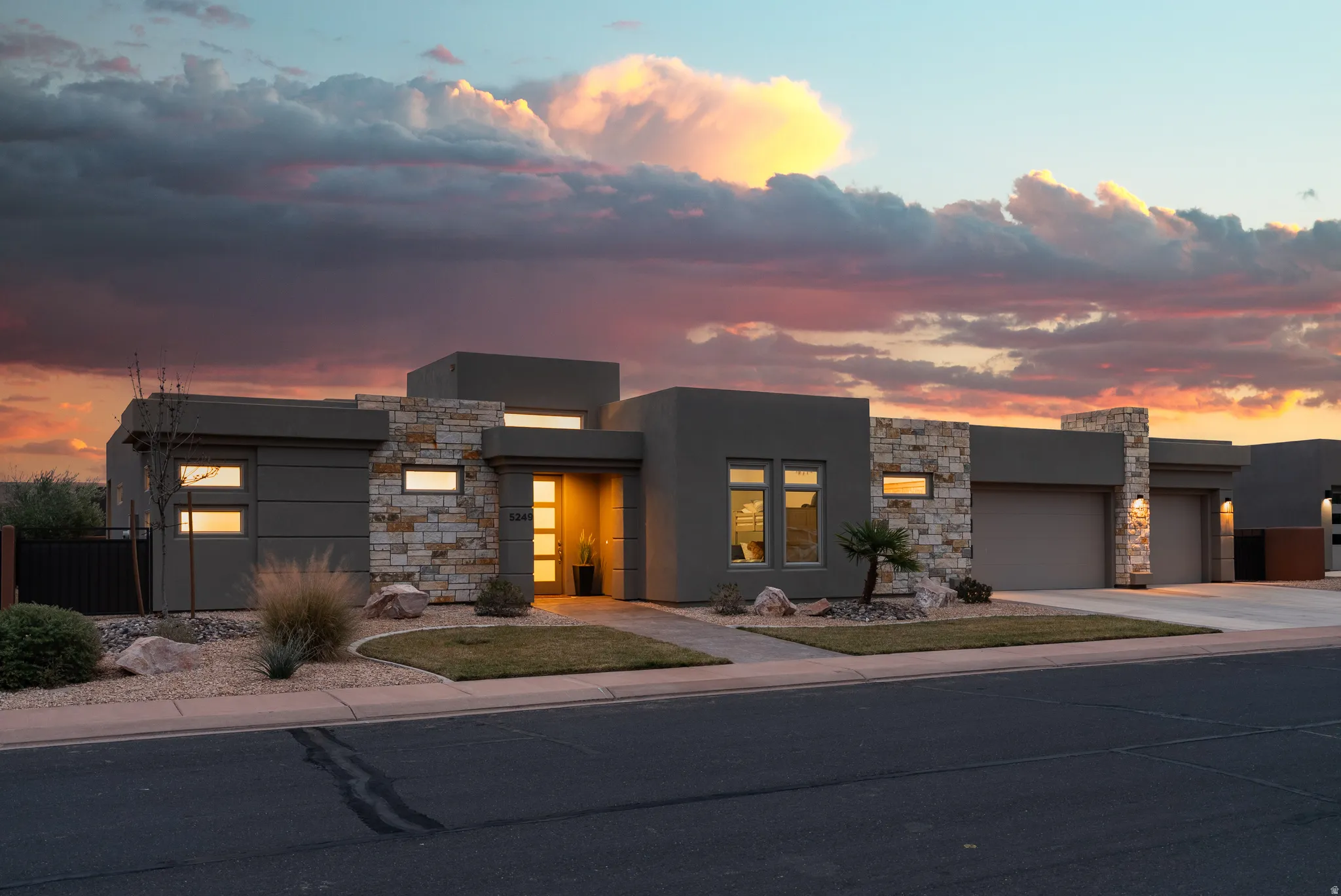 Modern exterior featuring stucco siding and stone accents