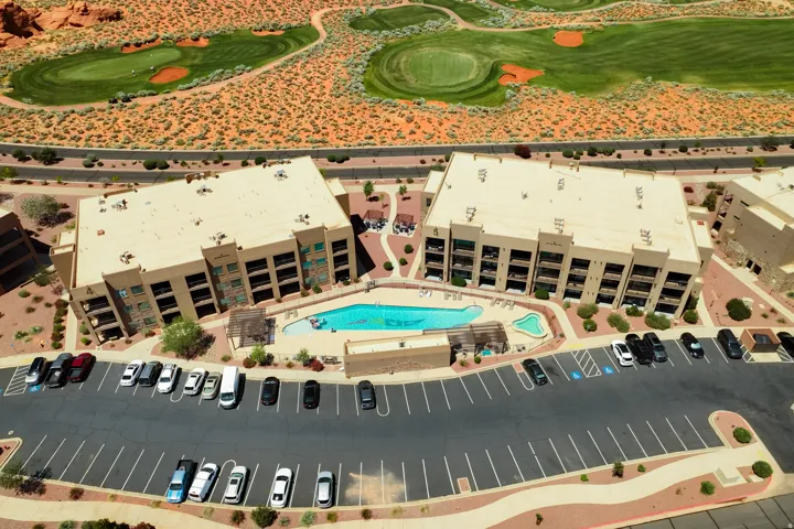 Resort-style residential complex featuring an outdoor swimming pool, integrated hot tub, and communal lounge areas