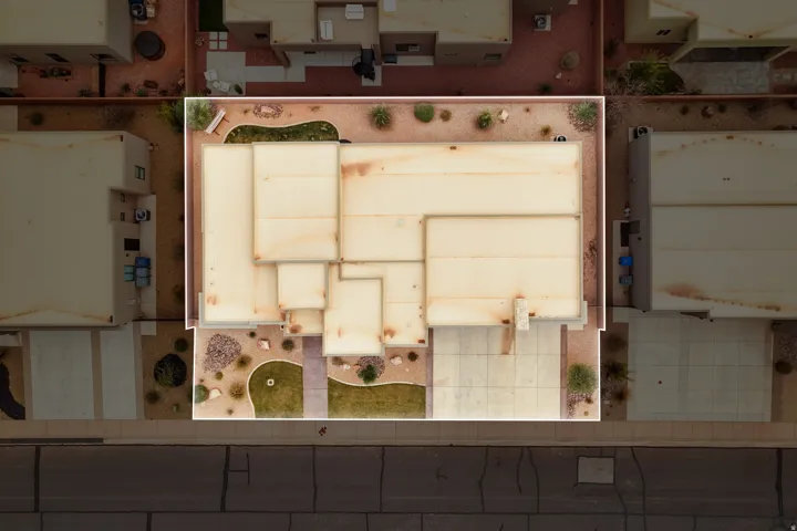 Aerial perspective showcasing a single-story residence with a multi-plane roofline