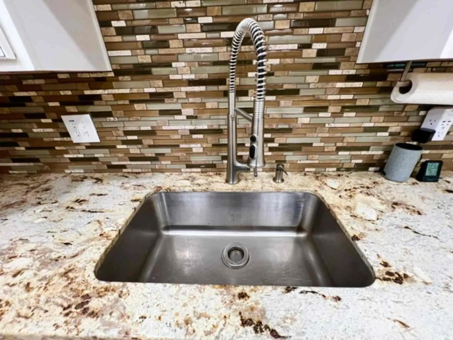 Stainless steel undermount sink with a high-arc pull-down faucet