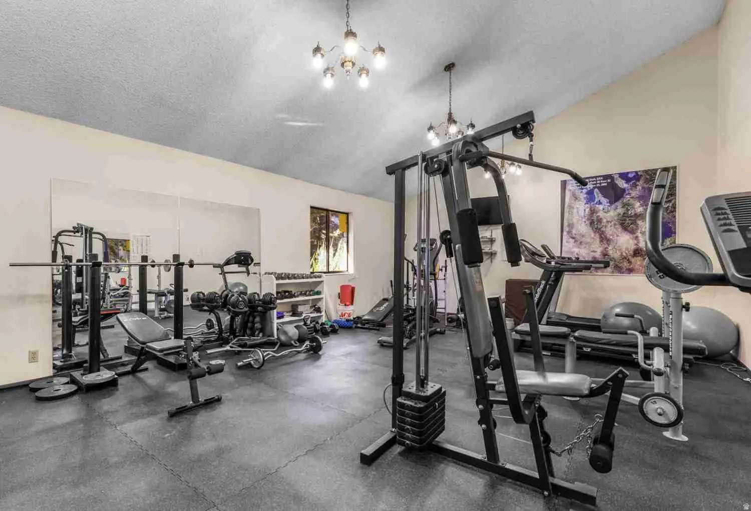 Dedicated fitness space featuring a sloped ceiling, recessed lighting, and a large wall-mounted mirror