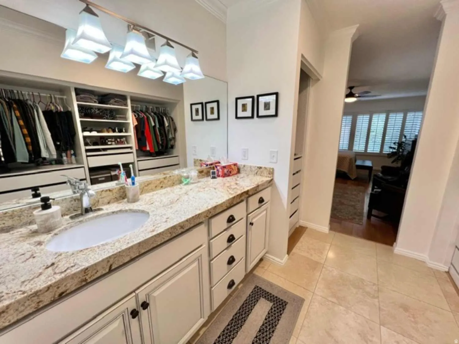 Vanity featuring an integrated sink, polished chrome faucet, and a stone-finish countertop