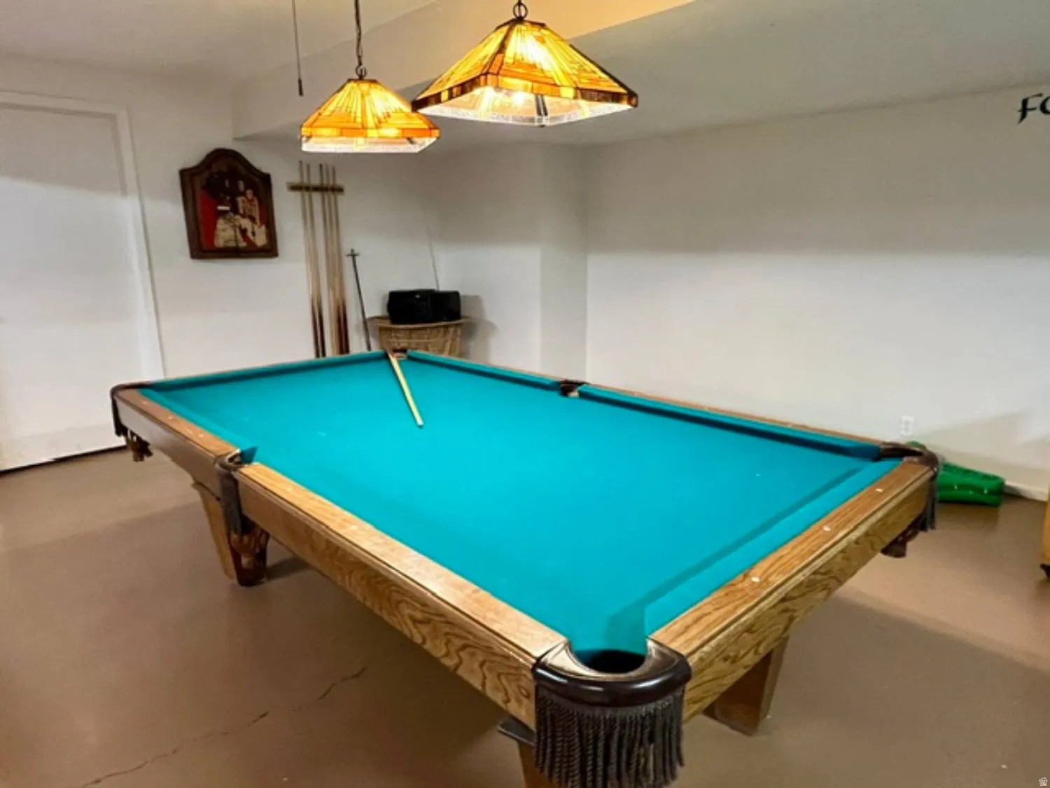 Recreation room featuring a full-size billiards table with a wood-finish frame and teal felt