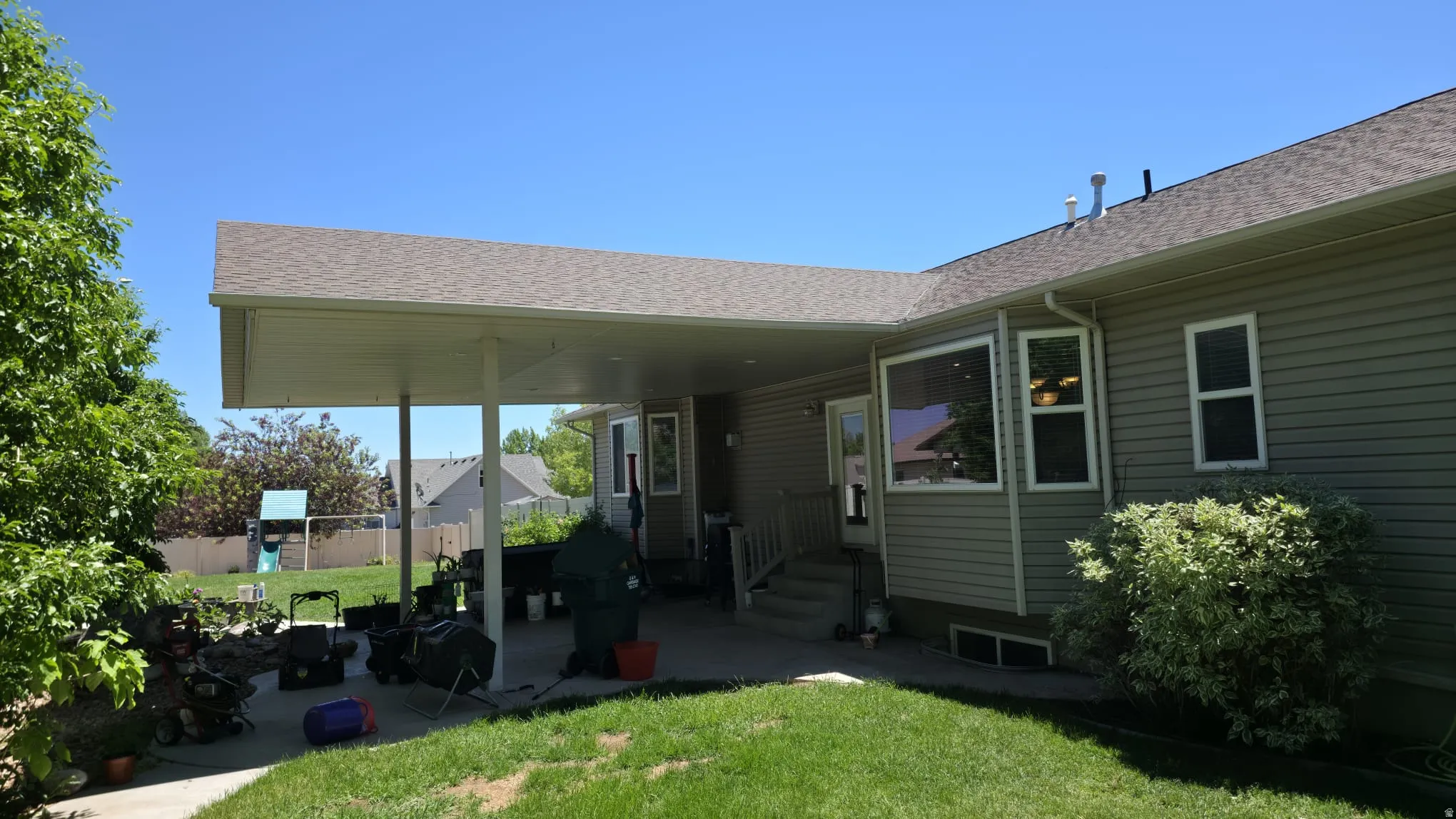 Expansive patio featuring a substantial overhead covering and direct exterior access