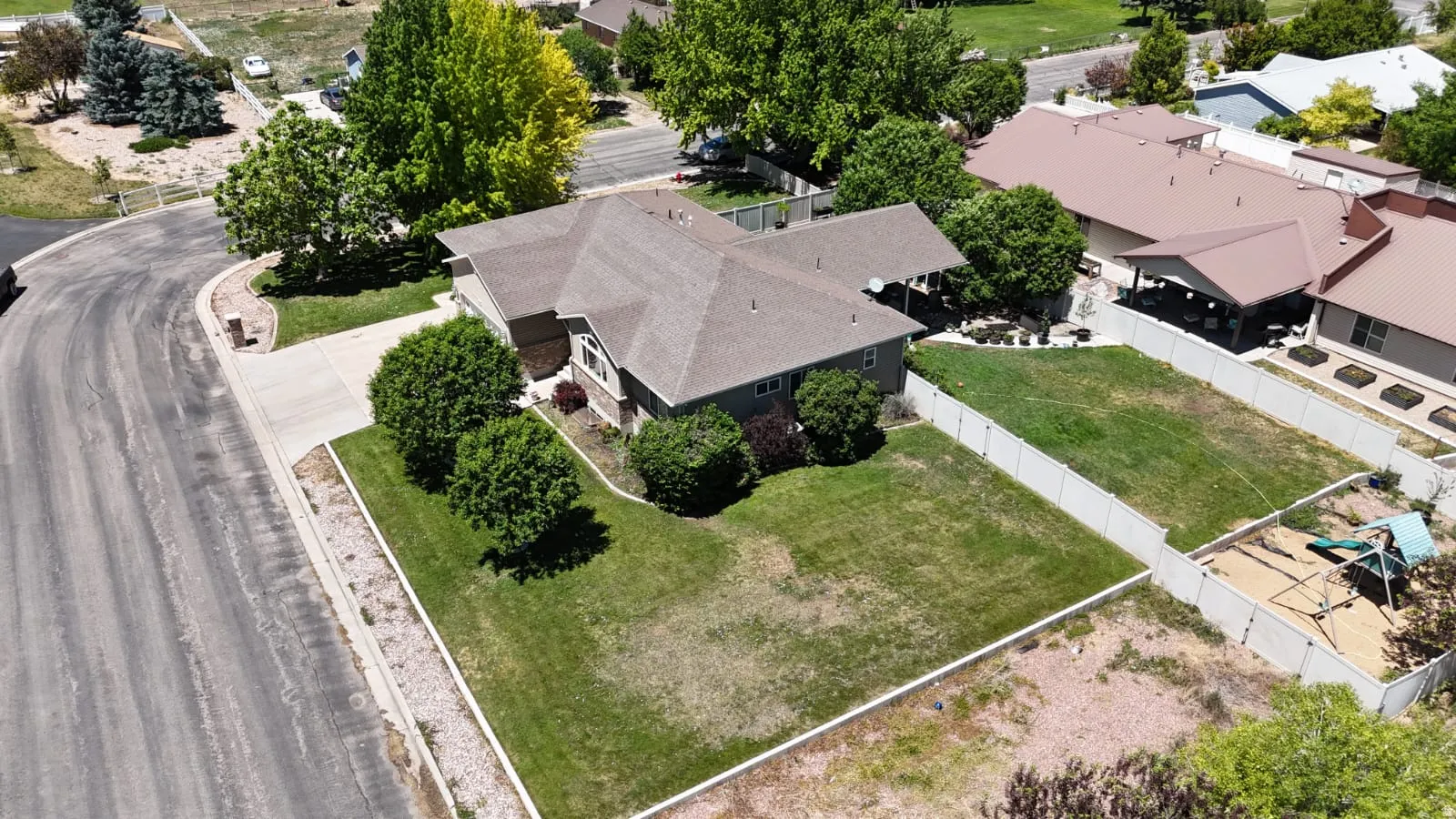 Corner lot property featuring a multi-gabled roofline and an attached carport