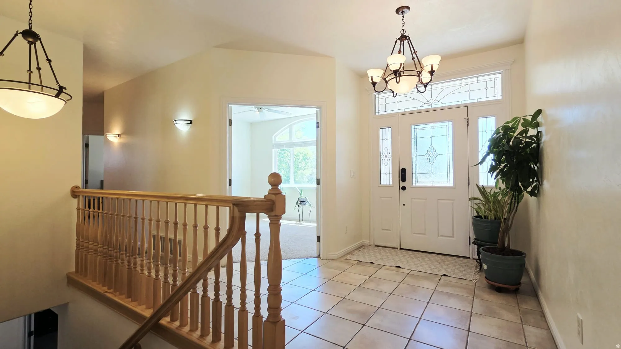Entryway featuring a double door with decorative glass inserts and transom window