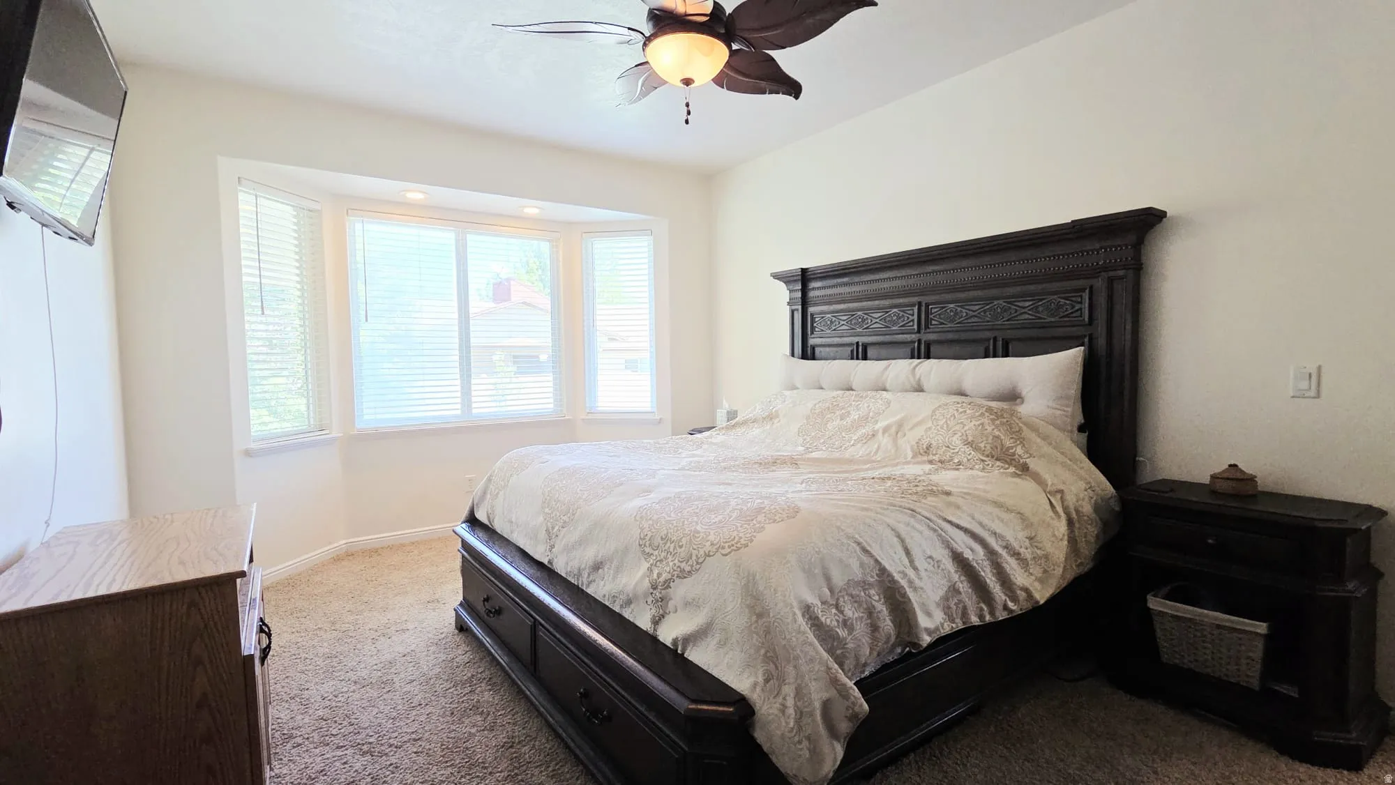Bedroom featuring a bay window with blinds, recessed lighting, and a ceiling fan
