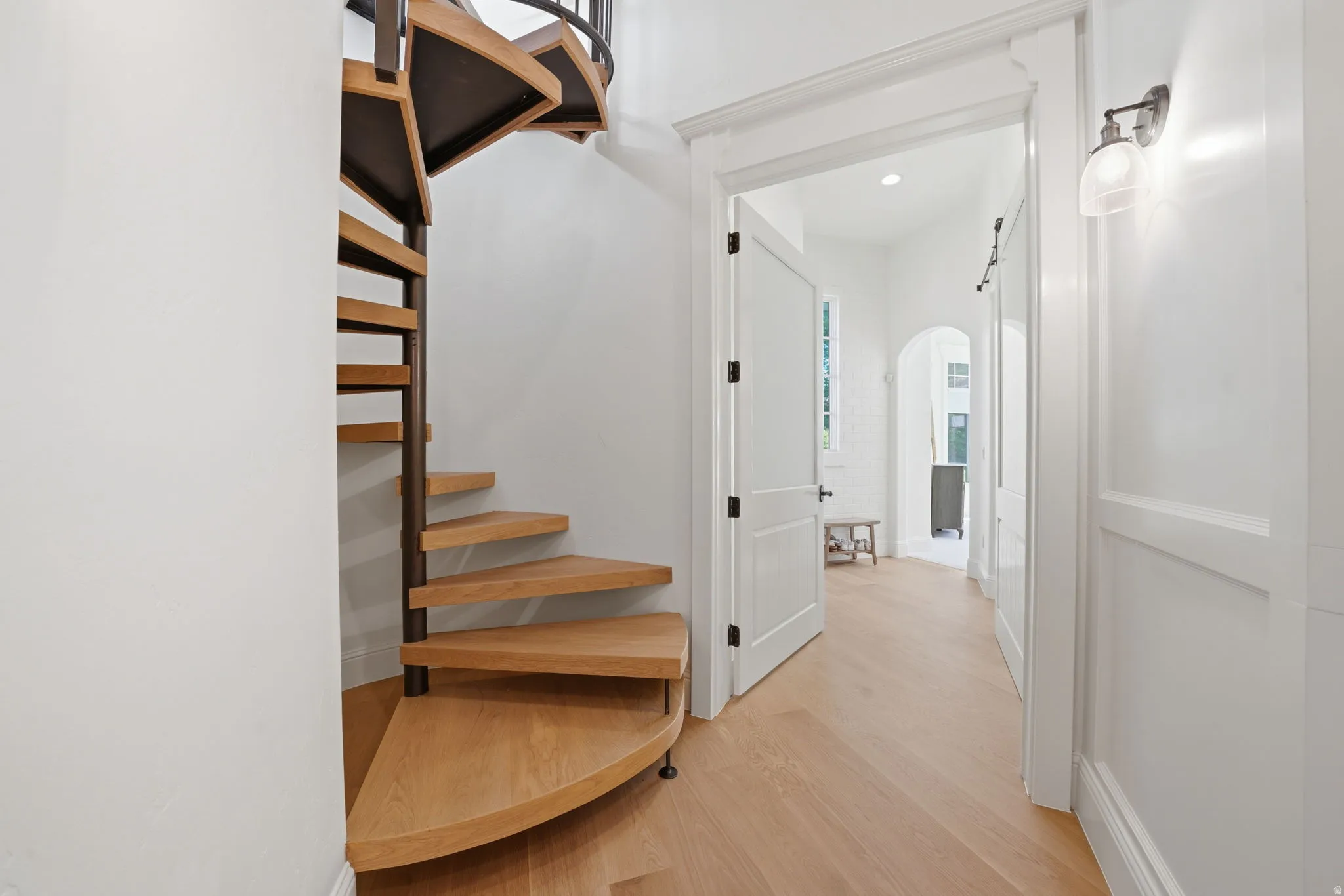 Spiral staircase with wood treads and a dark metal frame