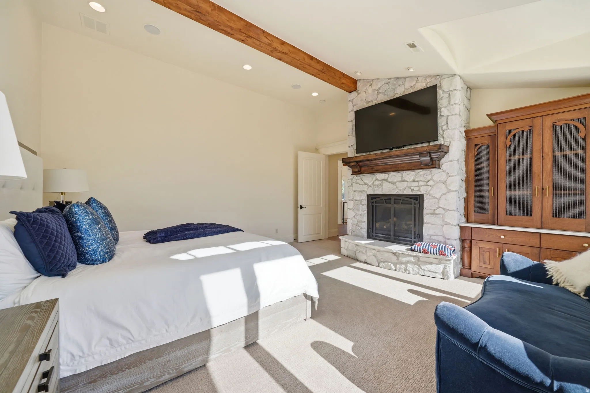 Stone fireplace with a dark wood mantel and hearth