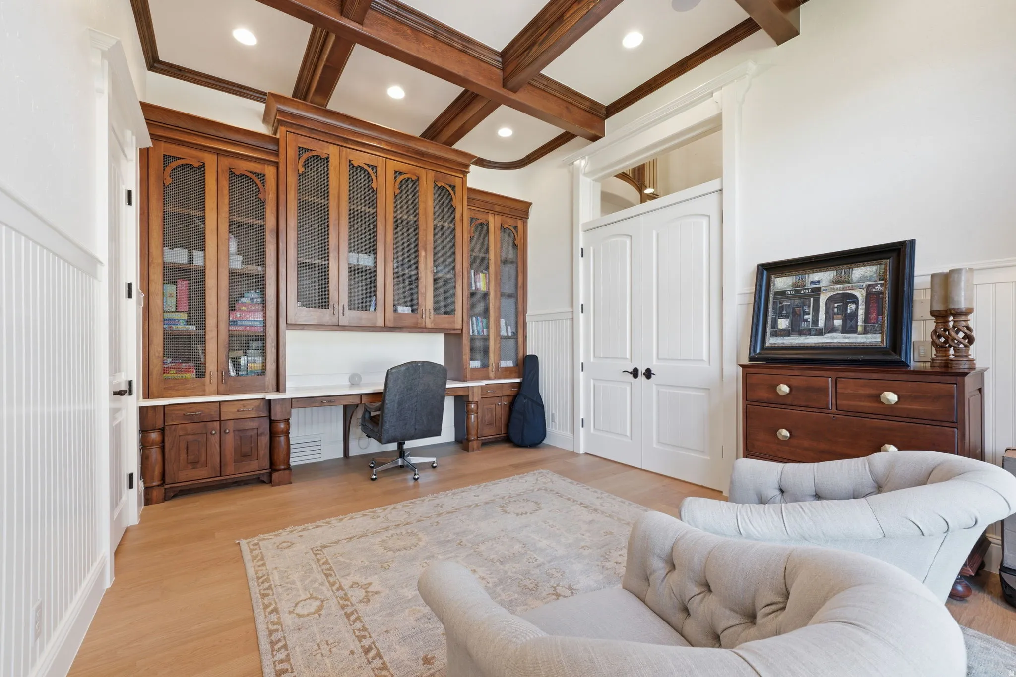 Custom built-in cabinetry with glass-front uppers and integrated desk space