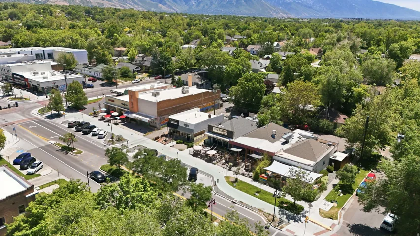 Aerial perspective showcasing a vibrant commercial district with multiple storefronts and street-level dining options