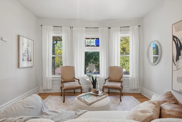 Bay window with three vertical windows, including a central stained glass accent