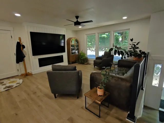 Bright living area featuring wood-finish flooring and recessed lighting