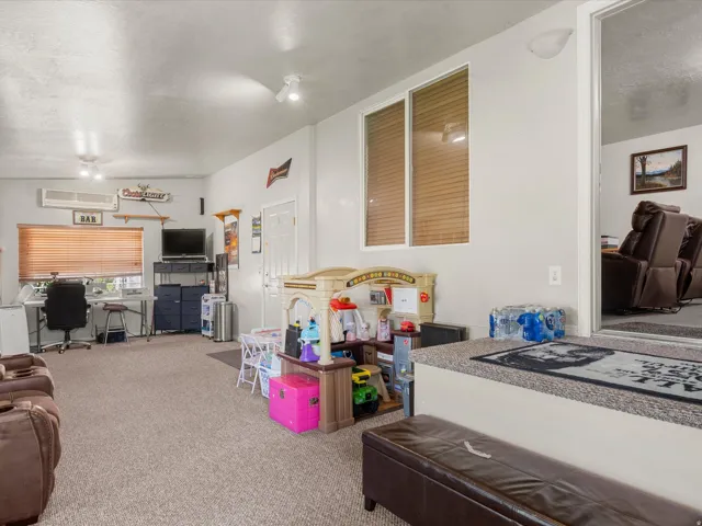 Versatile interior space featuring light-colored walls and neutral carpeting
