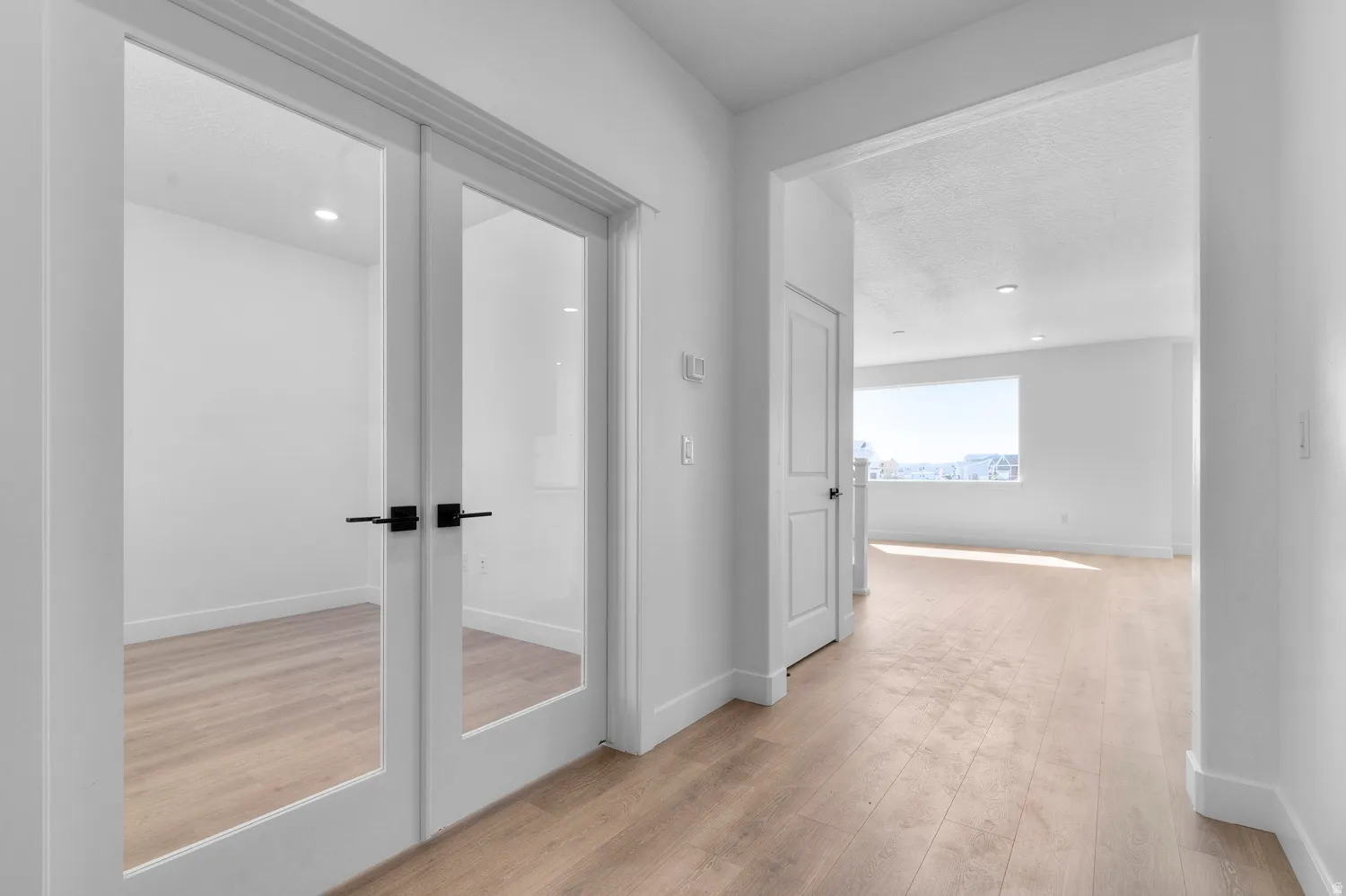 Entryway featuring light wood-finish flooring, white walls, and recessed lighting