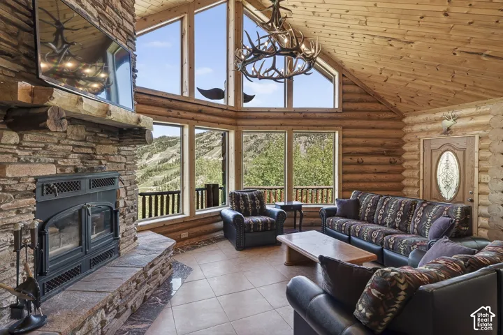 Vaulted wood-paneled ceiling with a decorative antler chandelier