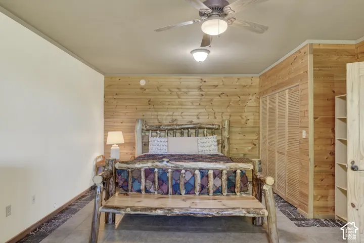 Room featuring a full wood-plank accent wall, light-colored walls, and dark flooring