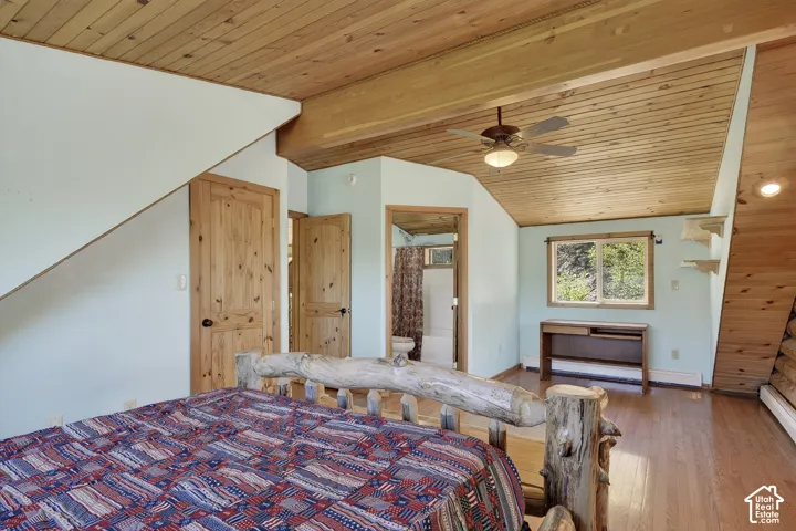 Wood-finish plank ceilings and matching wood-finish flooring characterize this room