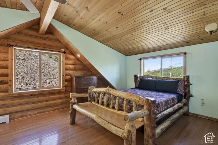 Log cabin interior featuring wood-finish flooring and a wood plank ceiling