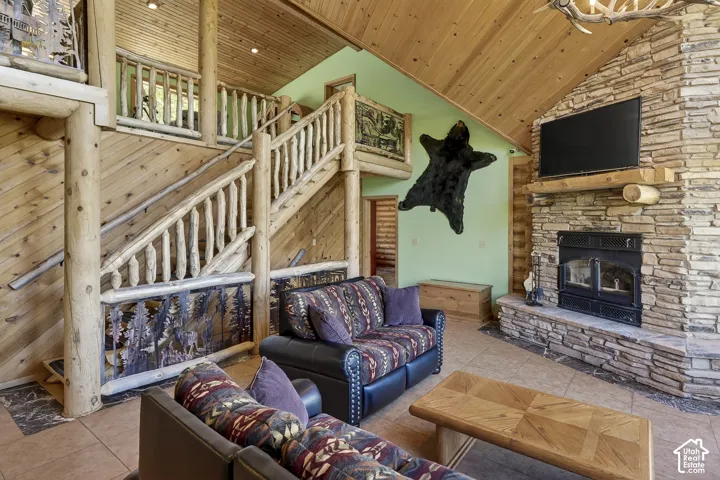 Vaulted wood-finish ceilings and walls complement the prominent stone-finish fireplace