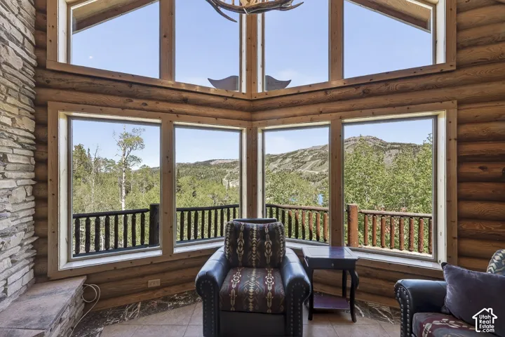 Expansive window wall with mountain and tree scenery