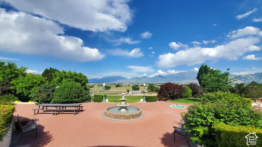 Expansive paver patio with a central tiered fountain