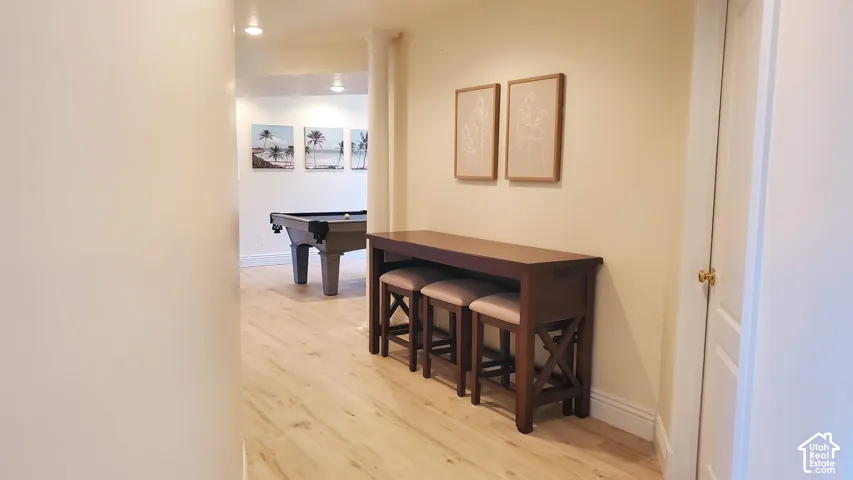 Recessed lighting illuminates wood-finish flooring throughout this versatile space