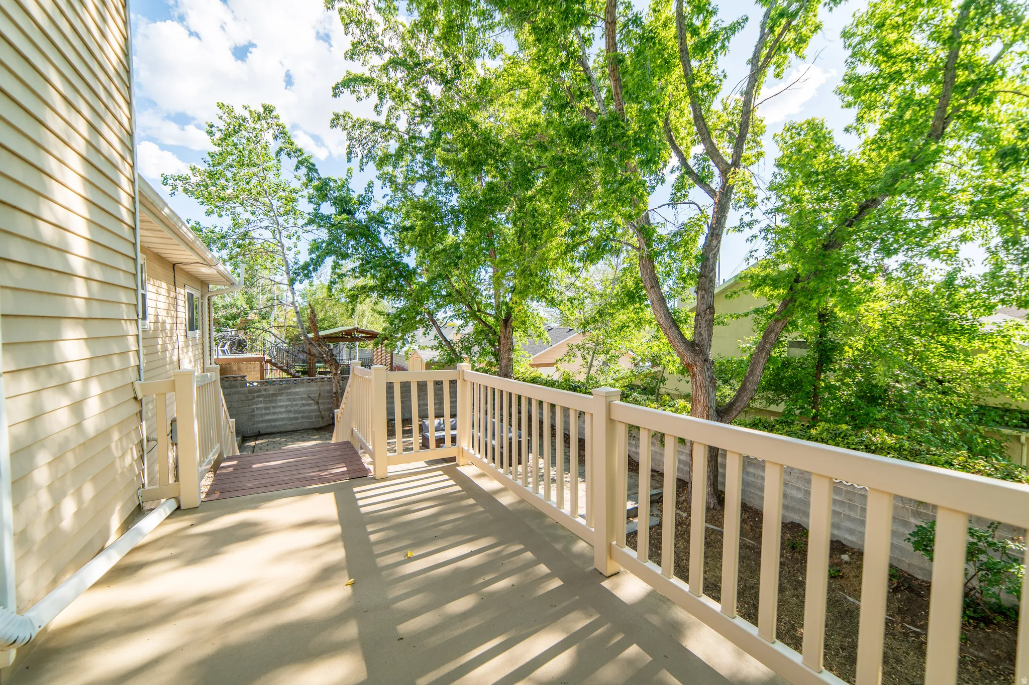 Outdoor deck with light-toned railings and a concrete surface