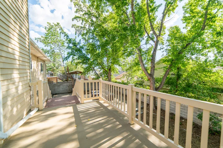 Outdoor deck with light-toned railings and a concrete surface