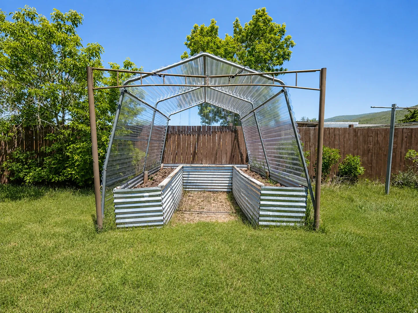 Dedicated gardening structure featuring a metal frame and clear paneling