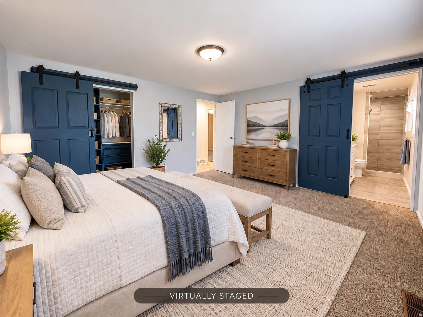 Carpeted flooring throughout, recessed lighting, and two deep blue barn doors