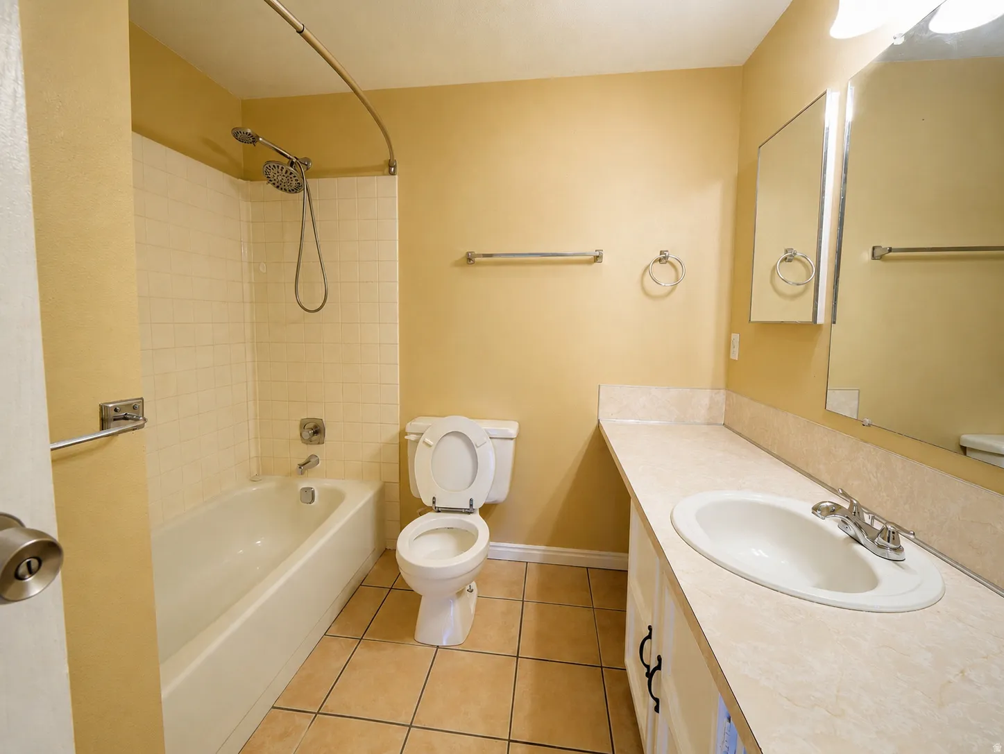 Bathroom featuring a built-in vanity with an integrated sink and laminate countertop
