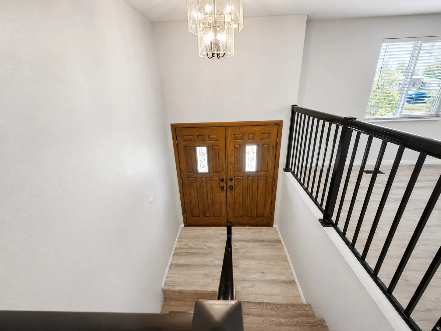 Dual wooden entry doors with decorative glass inserts