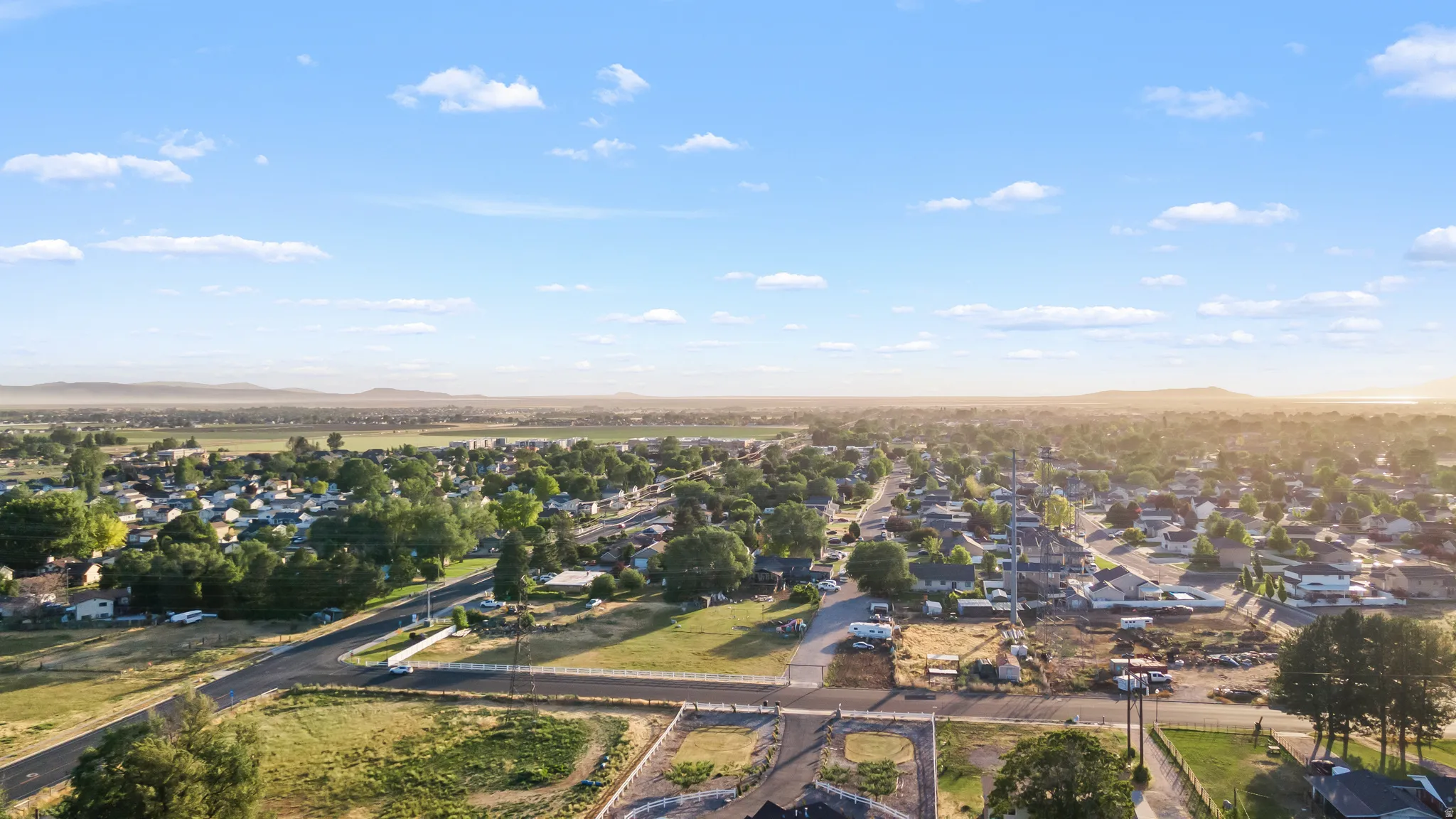 Expansive aerial capturing a developed residential area with scattered mature trees