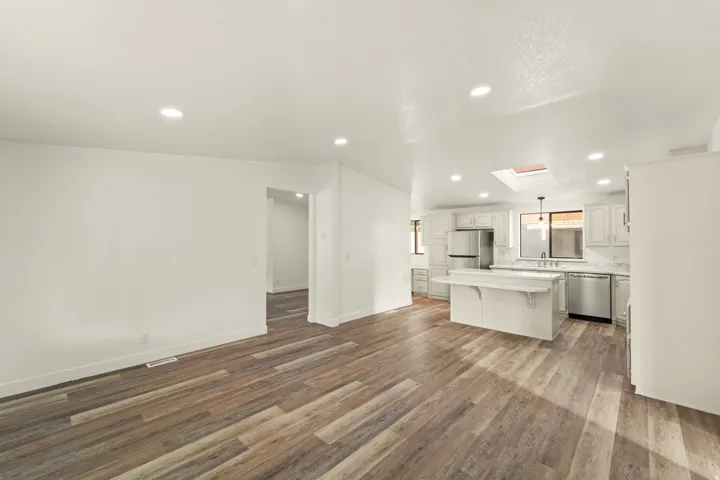 Open-concept living space featuring wood-finish flooring and recessed lighting