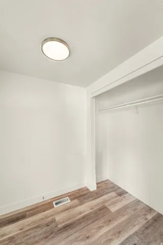 Recessed closet with a single hanging rod and shelf