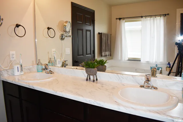 Dual vanity with integrated oval sinks and chrome fixtures