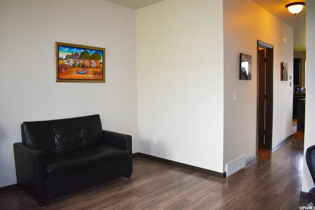 Expansive interior space featuring wood-finish flooring, white walls, and dark trim details