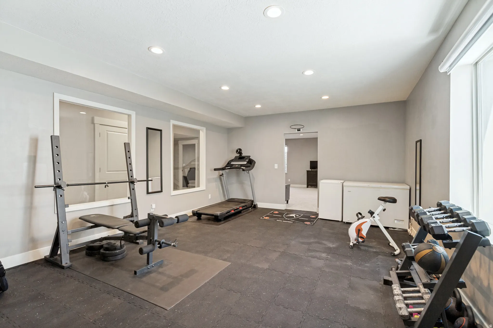 Spacious room with gray walls and recessed lighting