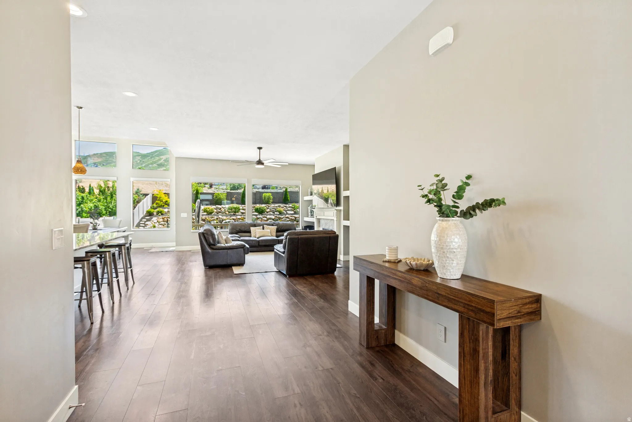 Open-concept living area with dark wood-finish flooring