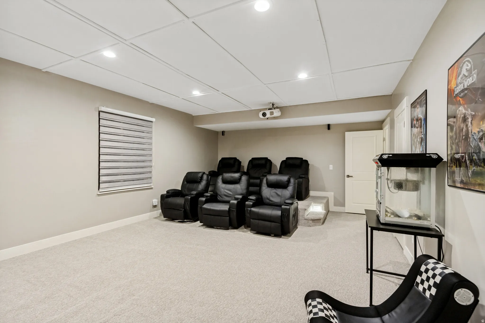 Dedicated media room featuring recessed lighting and wall-mounted projector