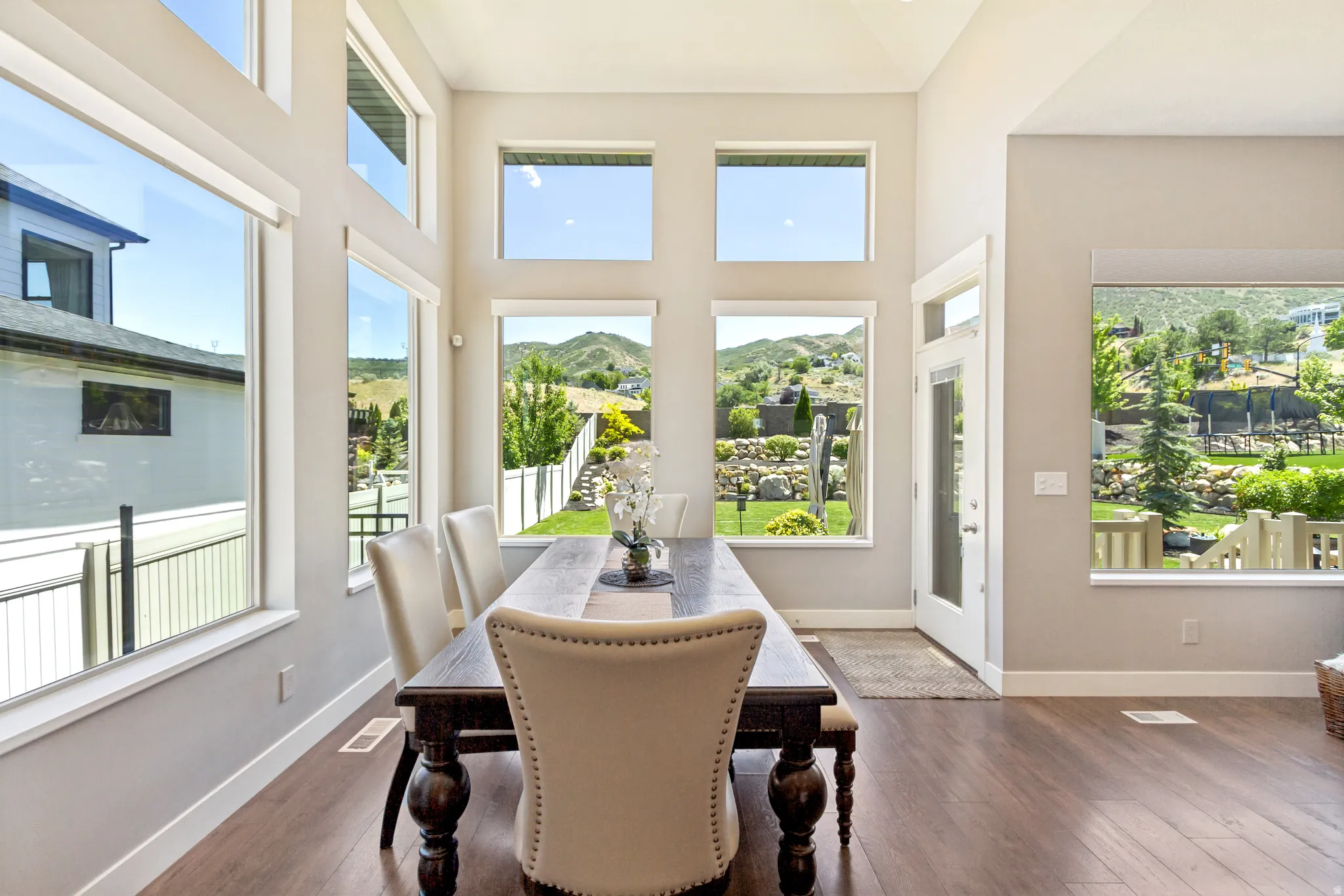 Dining area featuring soaring ceilings and extensive natural light from multiple windows