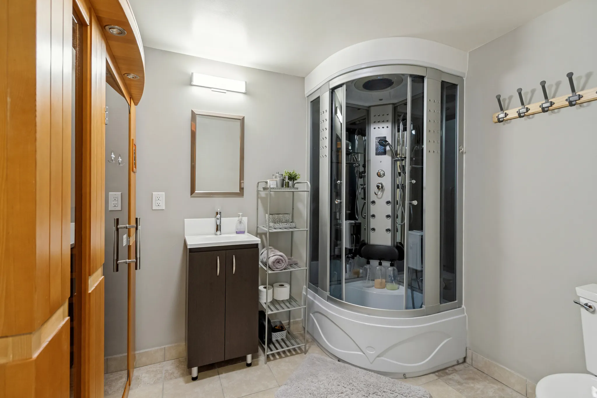 Corner shower unit featuring multiple body jets and integrated seating