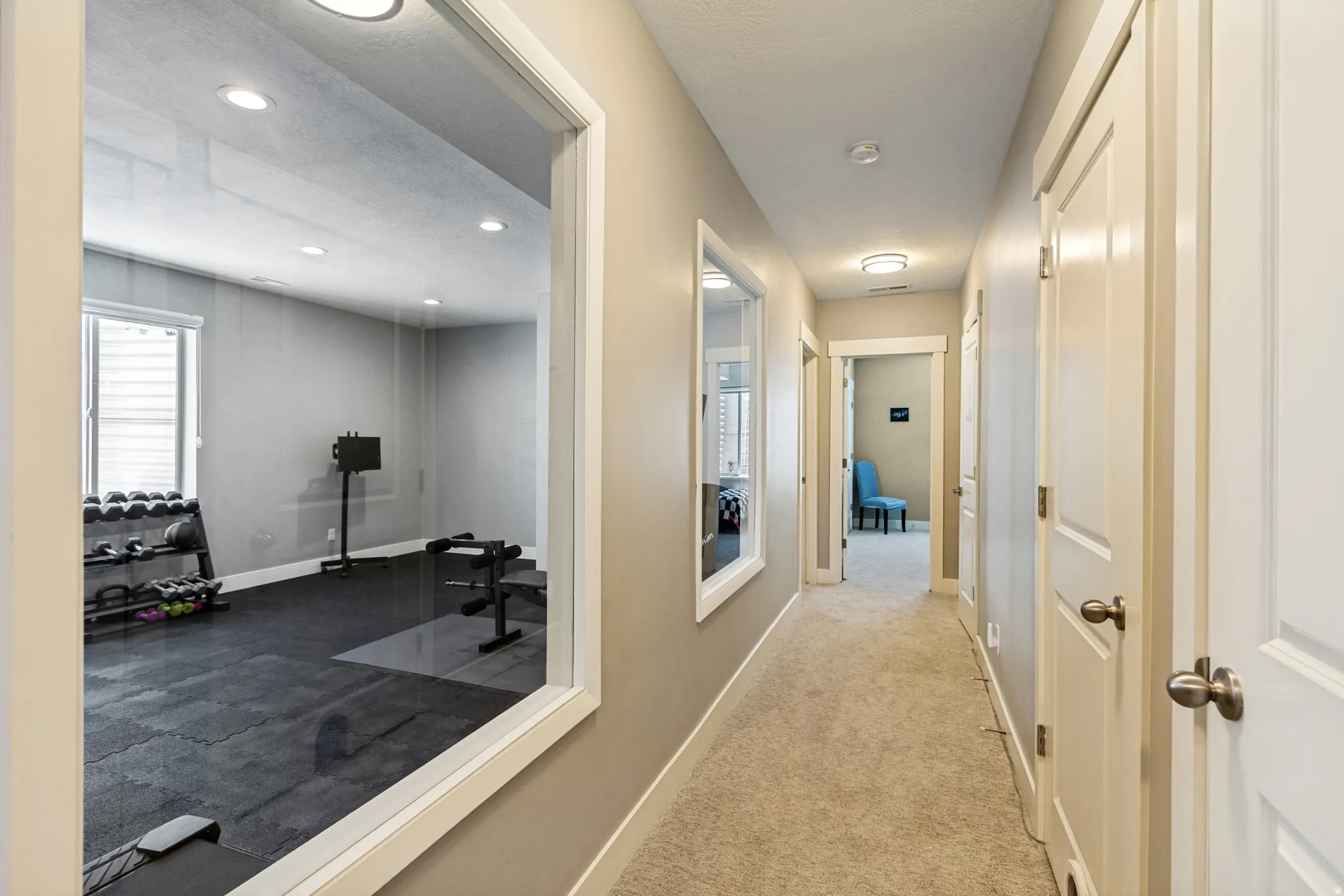 Dedicated fitness room featuring dark gray wall paint, recessed lighting, and rubber mat flooring