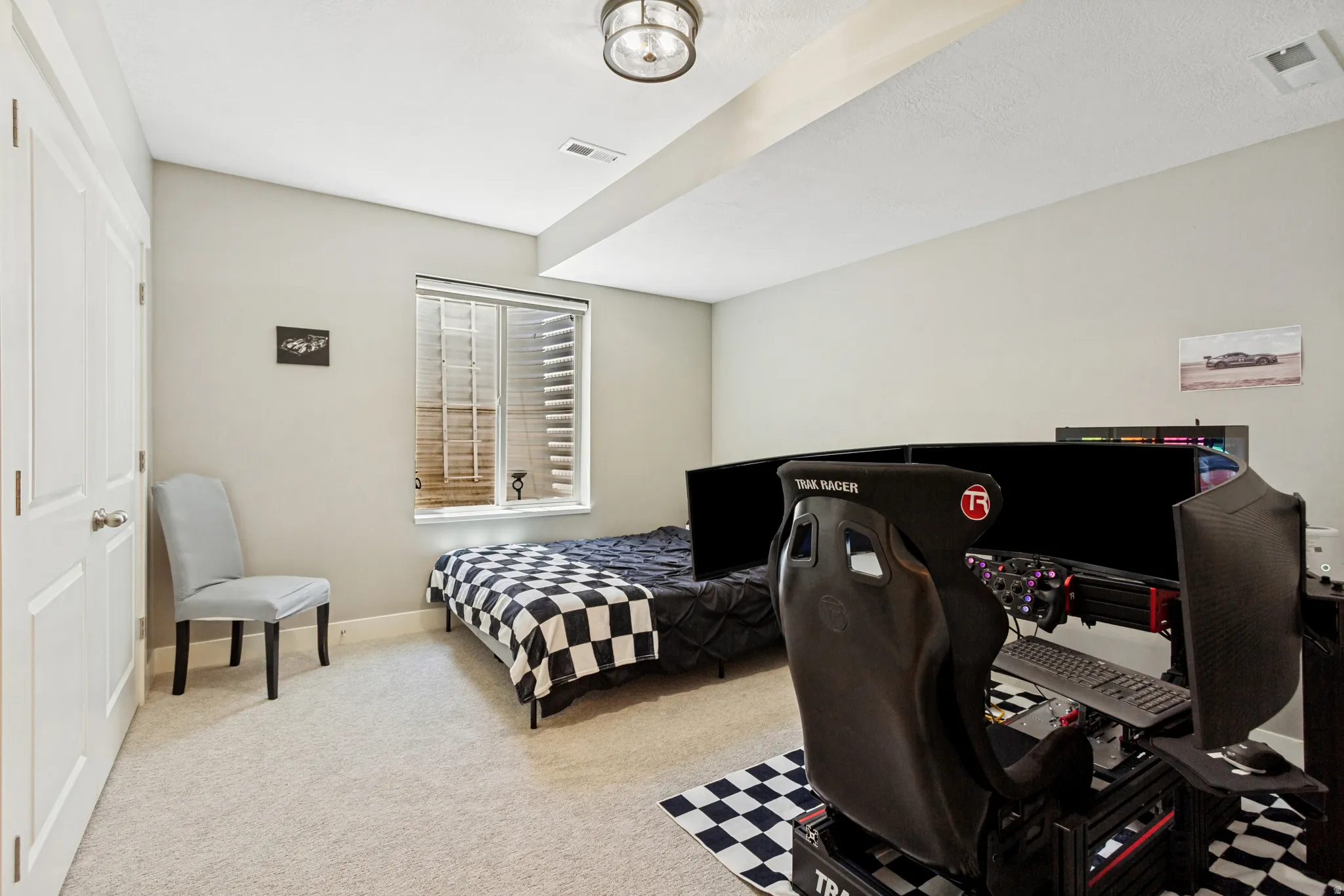 Carpeted room featuring a ceiling light fixture, white interior doors, and a window with horizontal blinds