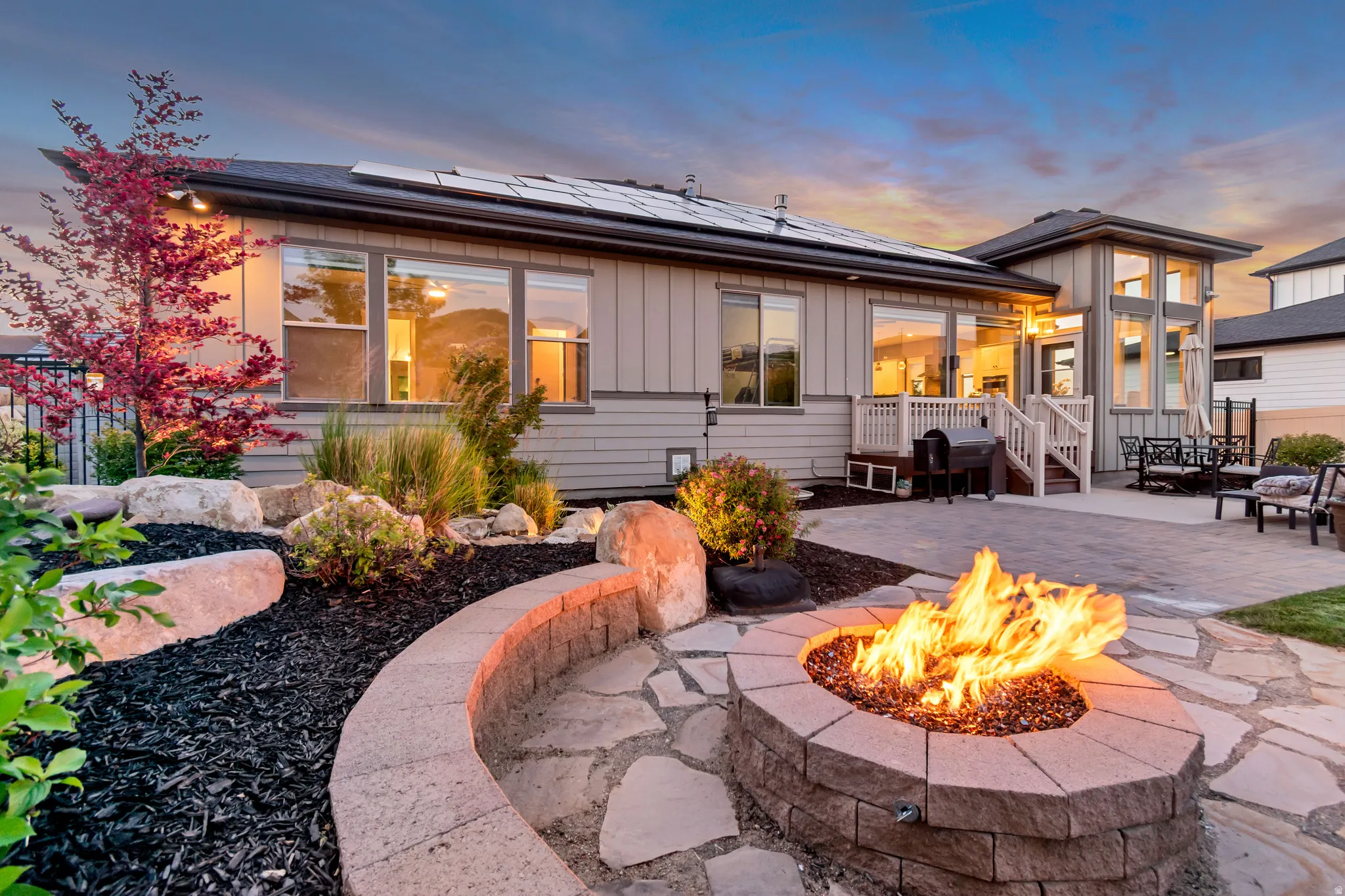 Flagstone patio featuring a built-in fire pit with a masonry surround