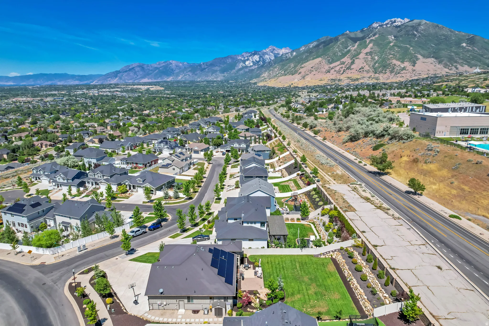 Expansive residential development featuring modern homes with dark roofs