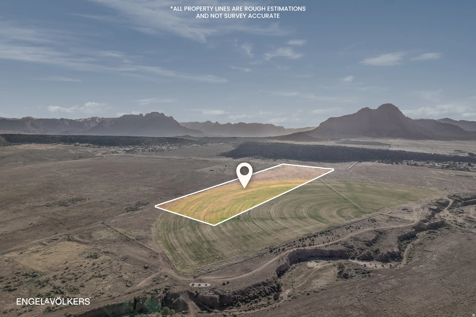Expansive land parcel featuring a portion of cultivated fields and surrounding arid terrain
