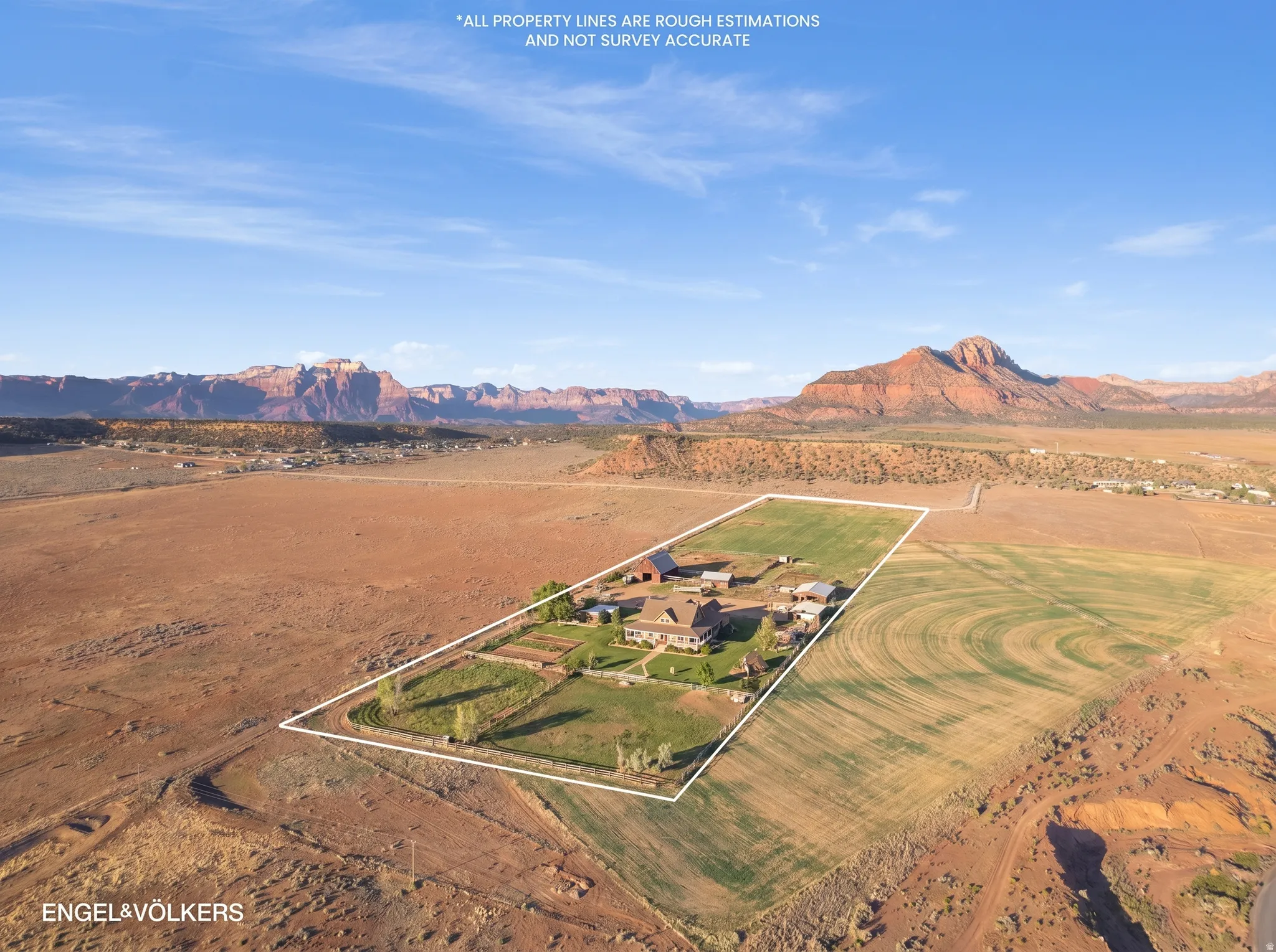 Expansive property featuring a central residence, multiple accessory buildings, and cultivated land