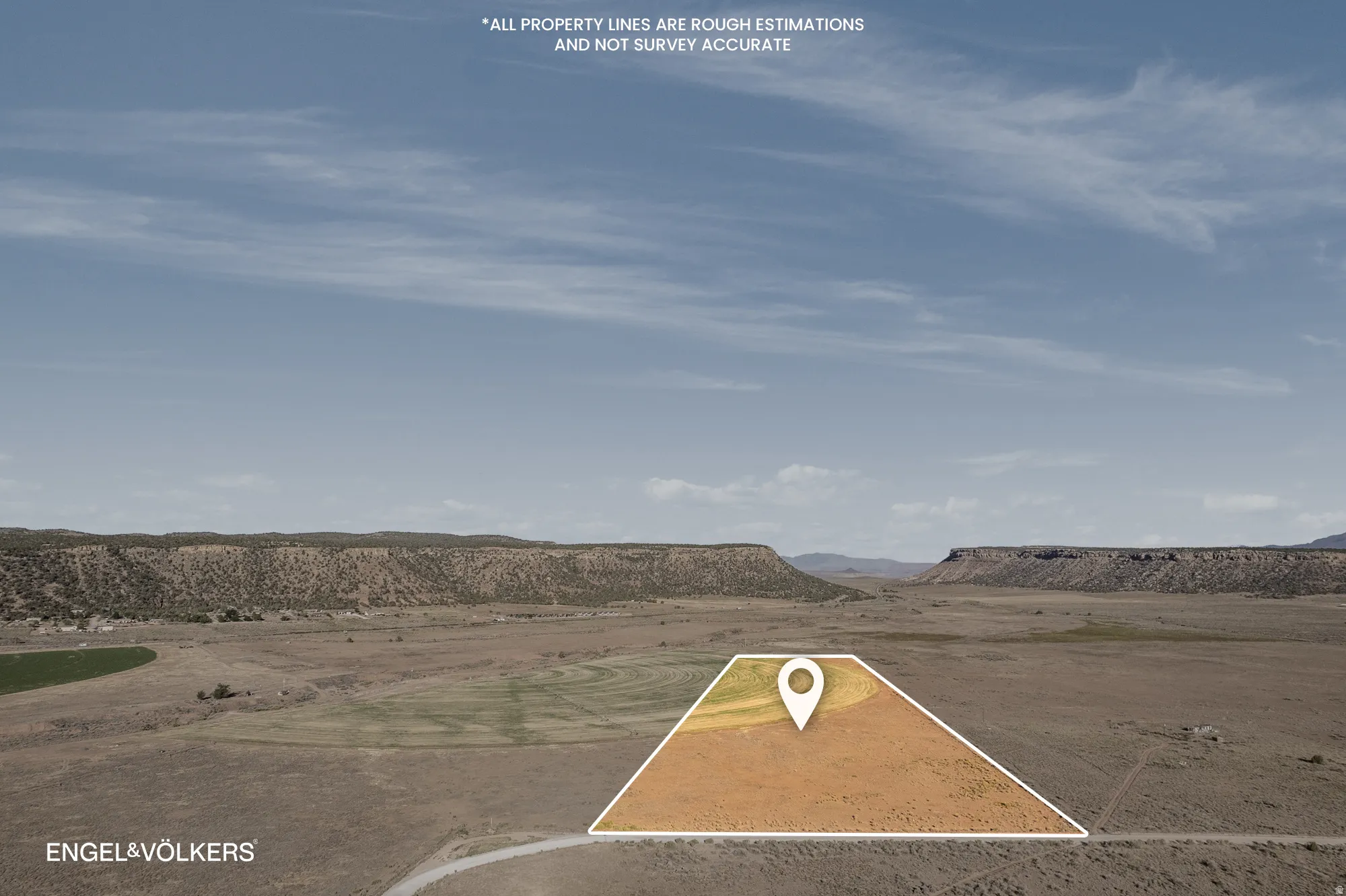 Expansive land parcel featuring a designated property outline and surrounding natural terrain